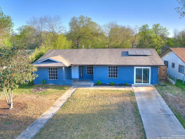 12226 La Barca, San Antonio, TX 78233 - view of front of house with solar panels, roof with shingles, covered porch, and brick siding