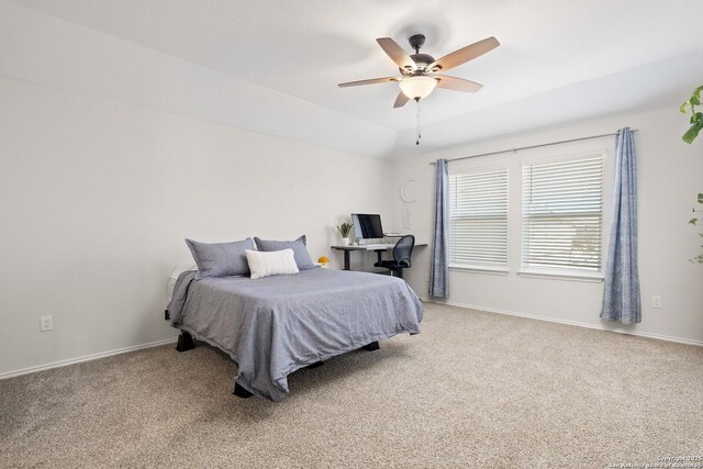 carpeted bedroom featuring lofted ceiling, baseboards, and ceiling fan
