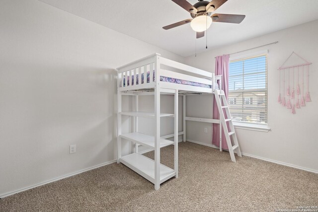 unfurnished bedroom featuring a ceiling fan, baseboards, and carpet floors