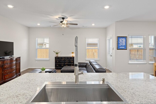 kitchen featuring visible vents, a ceiling fan, a sink, open floor plan, and recessed lighting