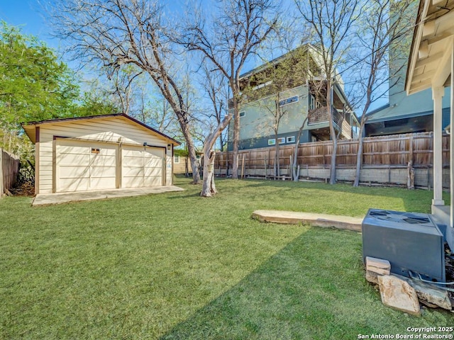 view of yard with a garage, an outdoor structure, and a fenced backyard