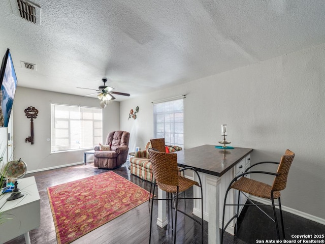 dining room featuring visible vents, wood finished floors, and a ceiling fan