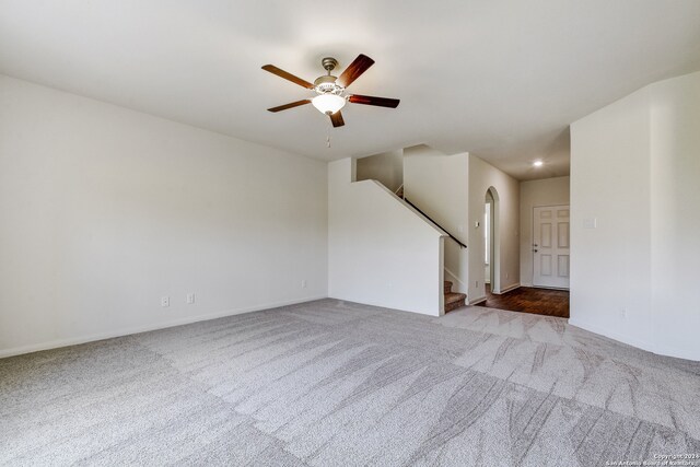 14914 Telfaire Mdw, Von Ormy, TX 78073 - carpeted empty room featuring baseboards, stairway, recessed lighting, arched walkways, and a ceiling fan
