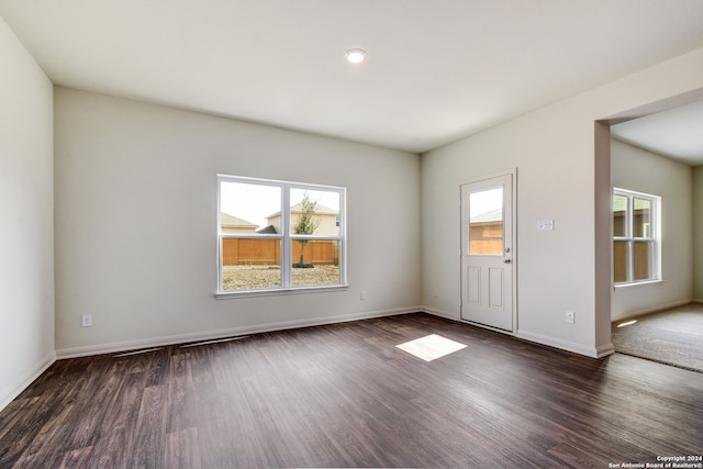 14914 Telfaire Mdw, Von Ormy, TX 78073 - spare room with baseboards, dark wood-type flooring, and a healthy amount of sunlight