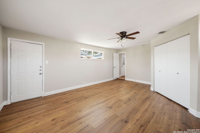 unfurnished bedroom with light wood-style floors, visible vents, and baseboards
