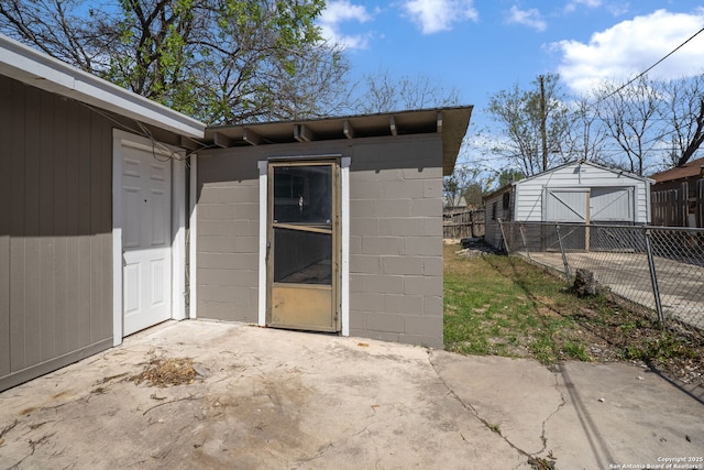 view of shed featuring fence