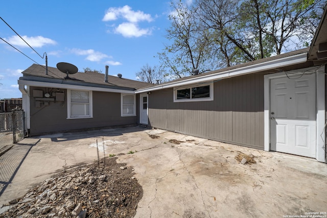 rear view of house with a patio and fence