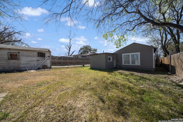 view of yard with an outdoor structure and a fenced backyard