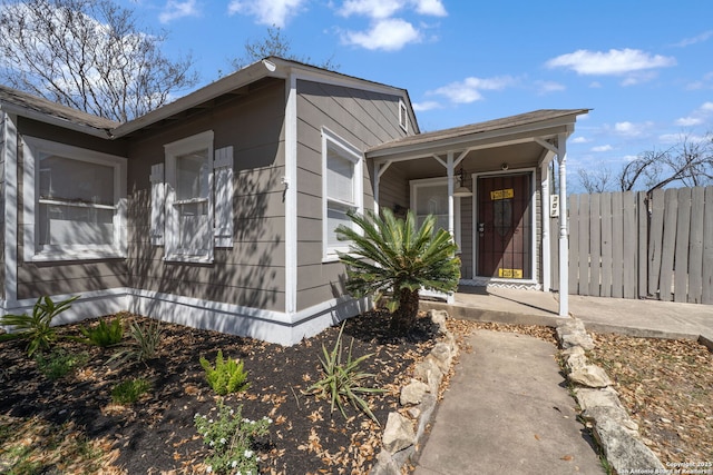 entrance to property featuring fence