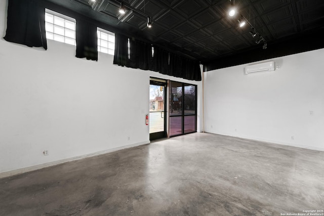 1651 W Woodlawn, San Antonio, TX 78201 - empty room featuring concrete floors, baseboards, plenty of natural light, and an AC wall unit
