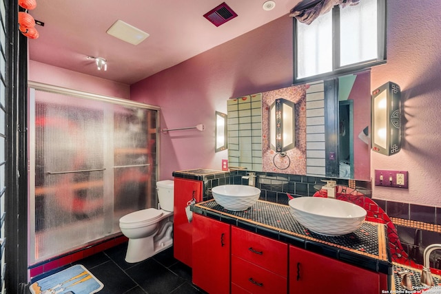 1651 W Woodlawn, San Antonio, TX 78201 - bathroom featuring a sink, toilet, a shower stall, and tile patterned floors