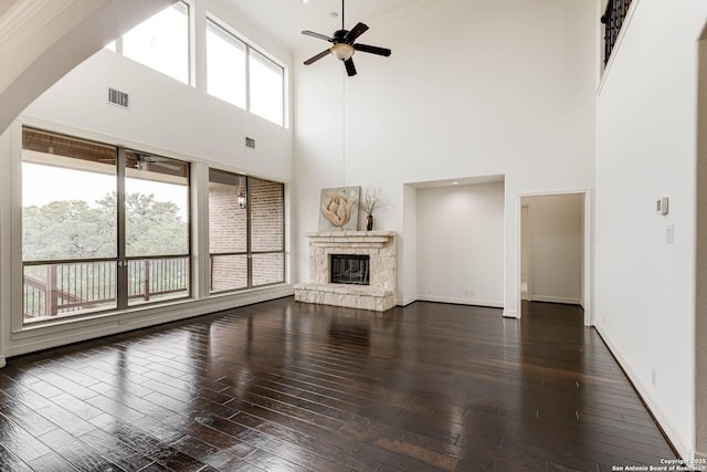 unfurnished living room with a ceiling fan, dark wood-style floors, and visible vents