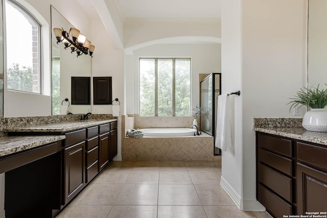 full bathroom with a garden tub, crown molding, tile patterned floors, a shower stall, and a sink