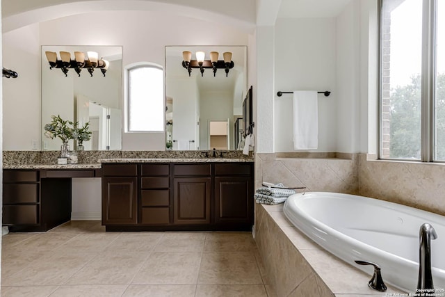 full bath featuring an inviting chandelier, vanity, tile patterned floors, and a bath