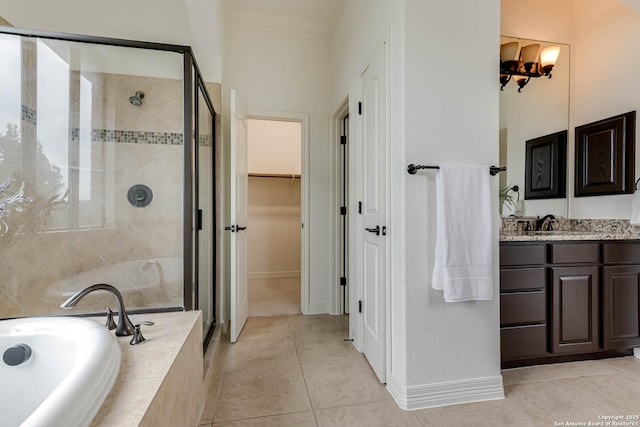 full bath with a garden tub, a walk in closet, tile patterned flooring, and a stall shower