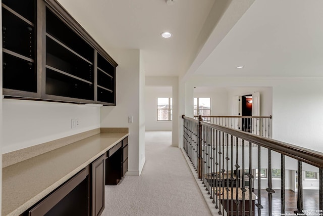 corridor with recessed lighting, baseboards, light carpet, and a healthy amount of sunlight