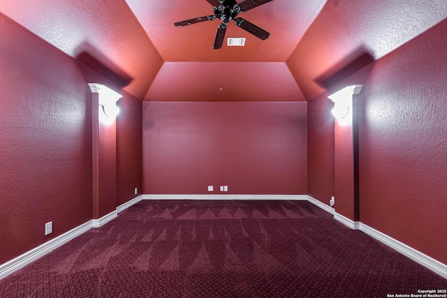 cinema with a ceiling fan, a textured wall, visible vents, and carpet