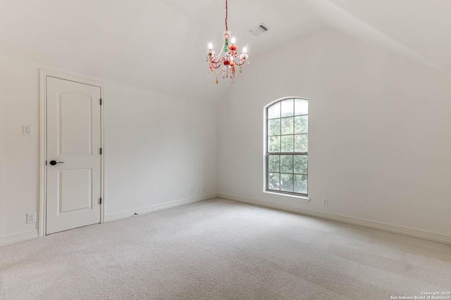 unfurnished room with light colored carpet, visible vents, baseboards, lofted ceiling, and an inviting chandelier