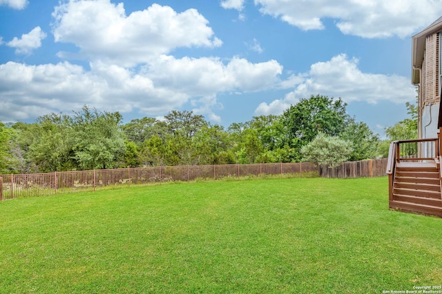 view of yard featuring stairs and a fenced backyard