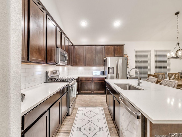 kitchen featuring a sink, stainless steel appliances, and dark brown cabinets