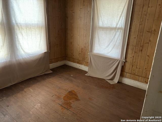 632 Canton, San Antonio, TX 78202 - unfurnished room featuring wood walls and wood-type flooring