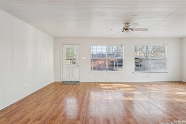 unfurnished living room with ceiling fan and wood finished floors