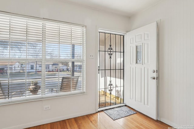 entryway with baseboards and wood finished floors