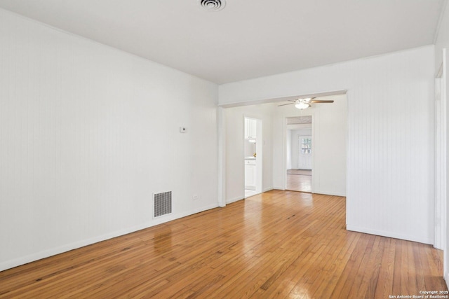 unfurnished room with visible vents, baseboards, light wood-style flooring, and a ceiling fan