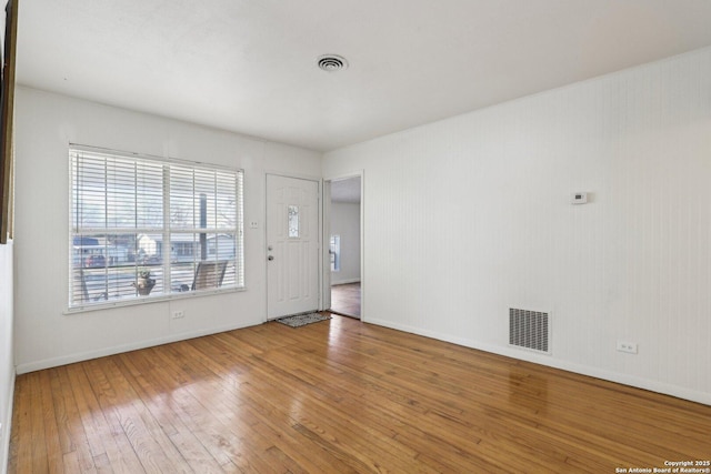 entryway featuring visible vents, baseboards, and hardwood / wood-style flooring