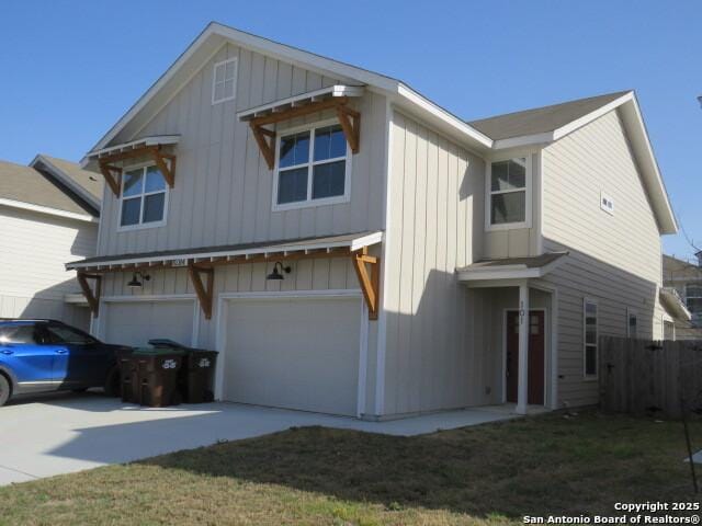 10314 Candlewood Way, San Antonio, TX 78245 - view of front of house featuring an attached garage, board and batten siding, fence, and driveway