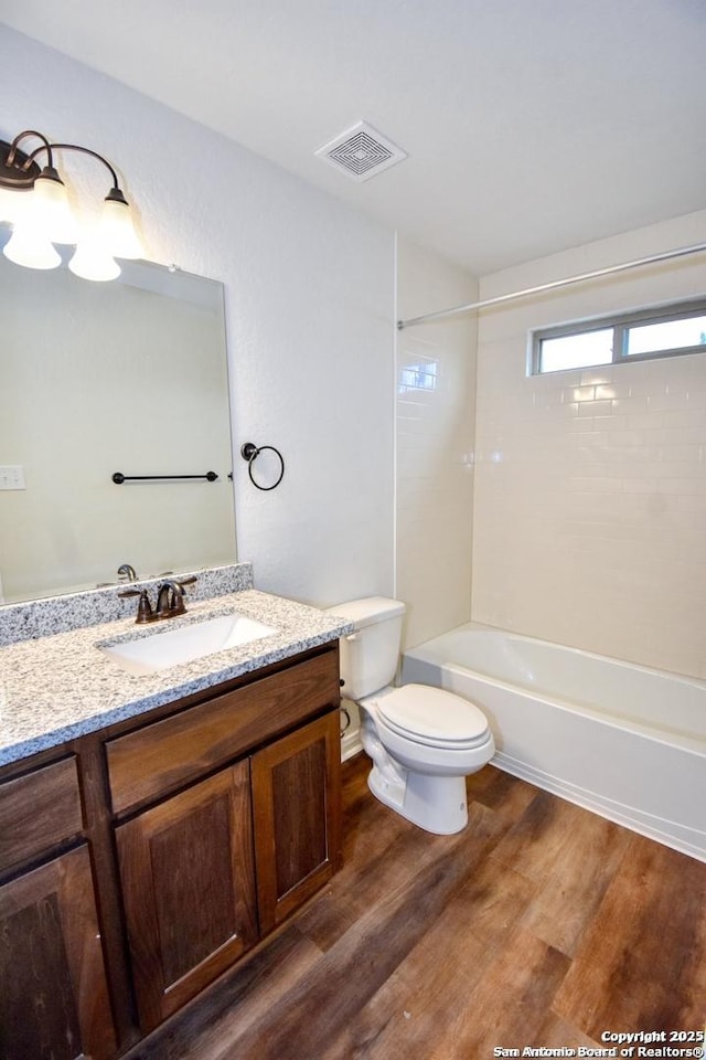 10314 Candlewood Way, San Antonio, TX 78245 - full bathroom with wood finished floors, toilet, vanity, and bathing tub / shower combination