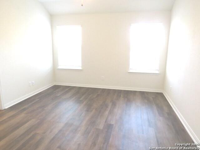 10314 Candlewood Way, San Antonio, TX 78245 - spare room featuring dark wood-style floors and baseboards