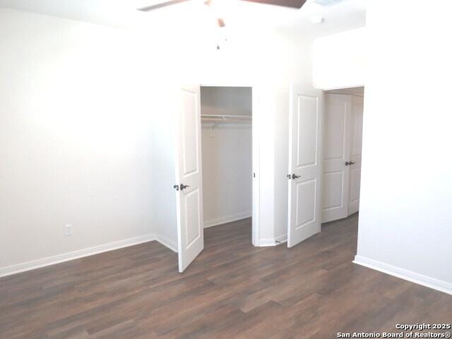 10314 Candlewood Way, San Antonio, TX 78245 - unfurnished bedroom with baseboards, dark wood-type flooring, a closet, and ceiling fan