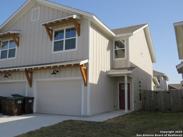 10314 Candlewood Way, San Antonio, TX 78245 - view of front of house featuring an attached garage, fence, driveway, and board and batten siding