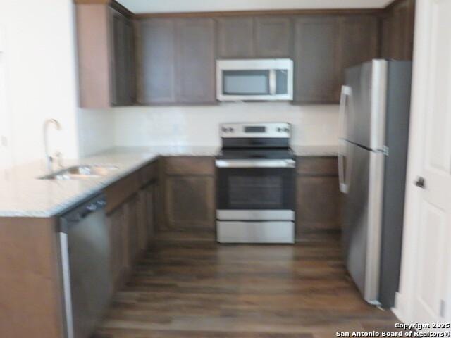 10314 Candlewood Way, San Antonio, TX 78245 - kitchen with stainless steel appliances, a sink, and dark wood-style flooring