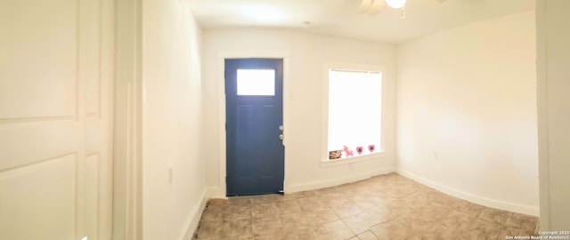 entrance foyer with baseboards and ceiling fan