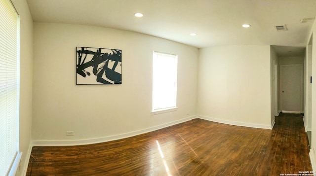 unfurnished room featuring dark wood finished floors, visible vents, recessed lighting, and baseboards
