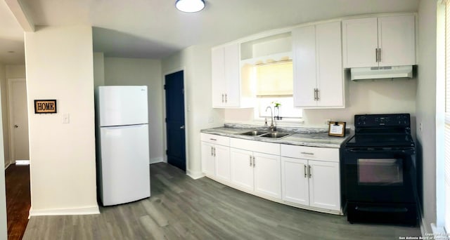 kitchen with freestanding refrigerator, a sink, under cabinet range hood, white cabinetry, and black electric range oven