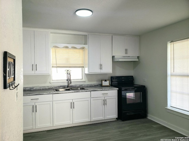 kitchen with under cabinet range hood, white cabinets, black / electric stove, and a sink