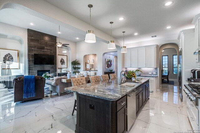 21335 Rembrandt, San Antonio, TX 78256 - kitchen with arched walkways, a kitchen breakfast bar, stainless steel dishwasher, and a sink