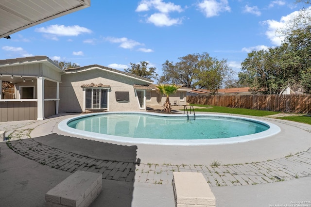 view of pool with a fenced in pool and fence