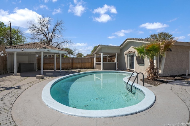 view of pool with a fenced in pool and fence