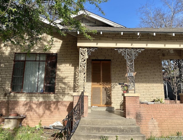 doorway to property featuring brick siding