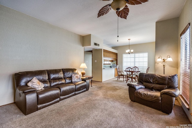 8633 Datapoint Unit 227, San Antonio, TX 78229 - living area with light colored carpet, a ceiling fan, and a chandelier