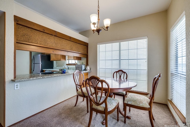 8633 Datapoint Unit 227, San Antonio, TX 78229 - dining room featuring light colored carpet and a chandelier