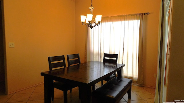 dining space with a chandelier and light tile patterned floors