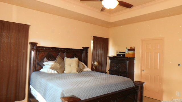 bedroom with ceiling fan, ornamental molding, and a raised ceiling