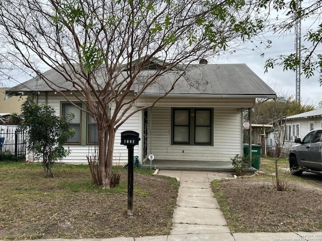 bungalow-style home with fence and covered porch