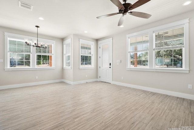 interior space with visible vents, baseboards, ceiling fan with notable chandelier, recessed lighting, and light wood-style floors