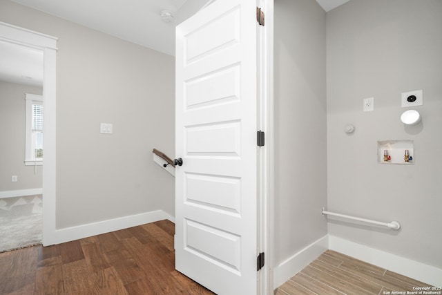 interior space featuring baseboards and wood finished floors